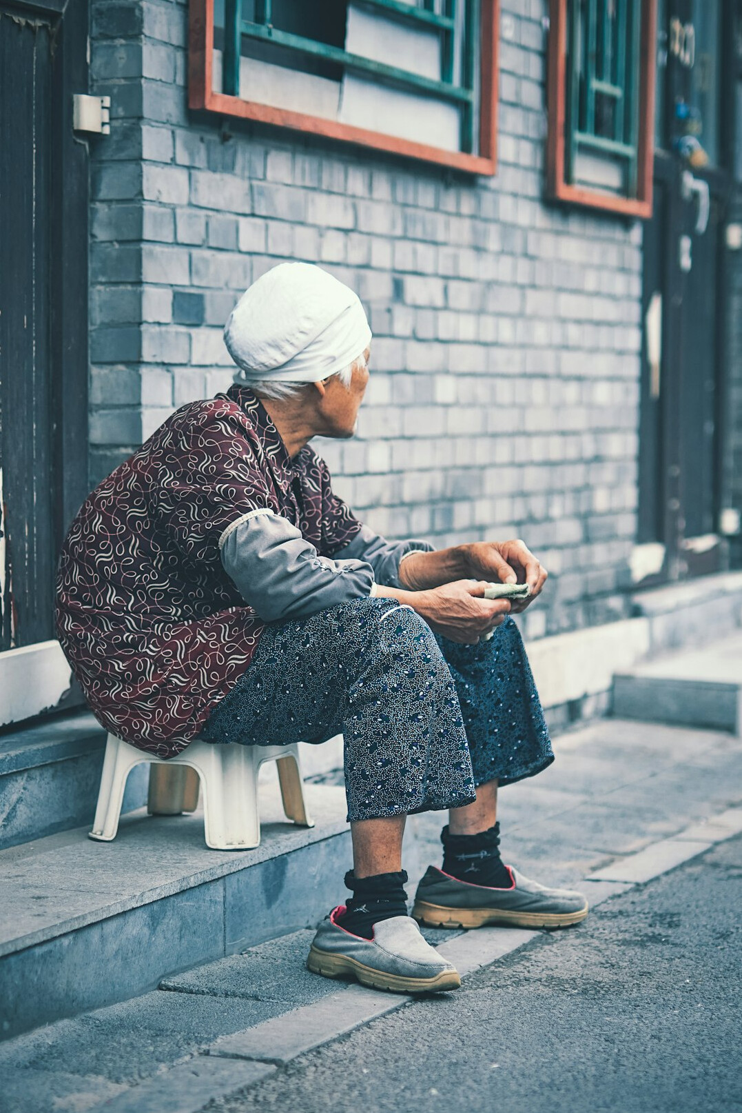Elderly woman smiling while using a tablet at home